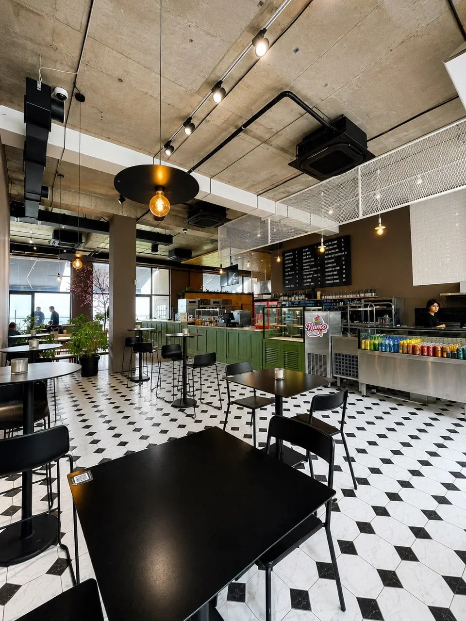 Social Tbilisi café service area with black-and-white tile flooring and flexible seating