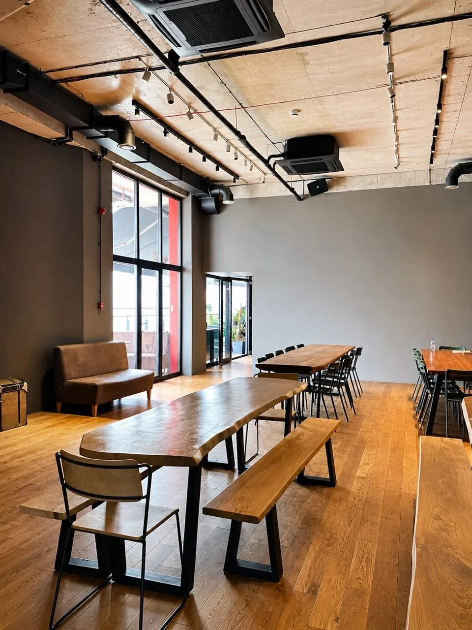 Social Tbilisi main indoor area with movable wooden tables, benches, and chairs